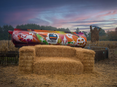 A giant sofa made from hay bales and a painted halloween-themed tanker