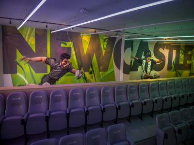 Tiered stadium-style seating facing a huge 