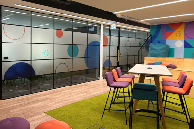 Nexthink office glass manifestations with desk and seating area